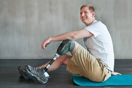 Photo for Man, amputee and workout with prosthetic legs for fitness, wellness and muscle health on floor. Happy person with disability and ready or on break for exercise, training and physio strength on ground. - Royalty Free Image