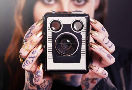 Photo for Tattoo, portrait or woman with retro camera in studio for hobby, creative photography or memory. Closeup, vintage technology or photographer with ink on hands or picture device on black background. - Royalty Free Image