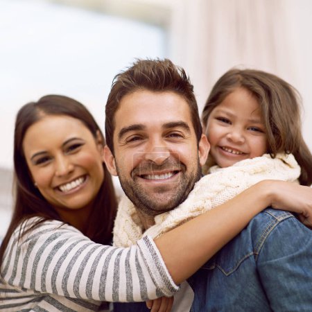 Photo for Mom, dad and kid in home for portrait with love or care, quality time and family bonding for memories or connection. Parents, girl child and together for comfort or safety on weekend, hug and closeup. - Royalty Free Image