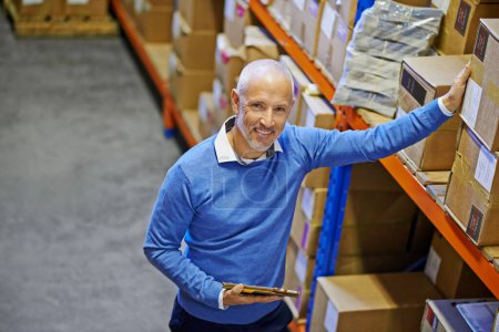 Photo for Above, box or portrait of man in warehouse for delivery order label, storage or stock in factory with tablet. Printing, happy mature manager or supplier inspection for package or wholesale shipping. - Royalty Free Image
