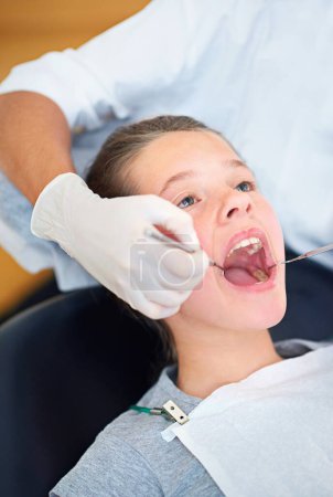 Photo for Girl, child and dental inspection with healthcare tool, dentist consultation and open mouth for oral health. Professional, kid patient and glove hand for teeth cleaning, gingivitis and medical care. - Royalty Free Image