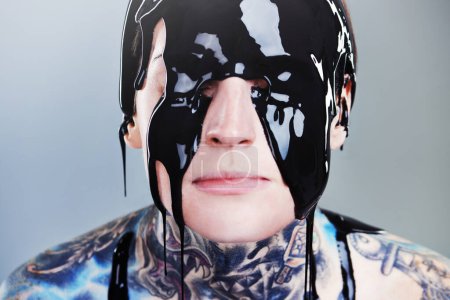 Photo for Abstract, paint and face with black ink for rock, tattoo and punk art in creative career isolated on gray background. Person, liquid and closeup for surreal, unique and grunge on studio backdrop. - Royalty Free Image