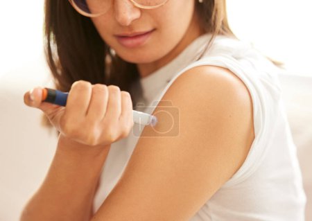 Woman, hands and insulin injection in arm for diabetes, medical condition and treatment at home. Needle, medication and syringe for health, wellness and person care with medicine for blood sugar.