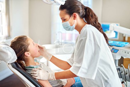 Photo for Tools, dentist and woman with child for exam, healthcare or orthodontics for teeth in clinic. Dental hygiene, kid and doctor with mask for patient, oral or cleaning mouth with medical pediatrician. - Royalty Free Image