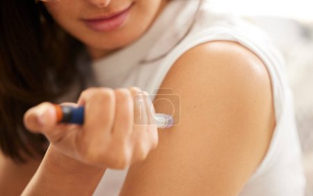 Person, hands and insulin injection in arm for diabetes, medical condition and treatment at home. Needle, medication and syringe for health, wellness and home care with medicine for blood sugar.