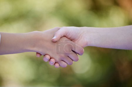 Photo for Teamwork, handshake and hands of people in nature for collaboration, agreement and thank you in park. Friends, diversity and closeup of gesture for solidarity, community and greeting hello outdoors. - Royalty Free Image
