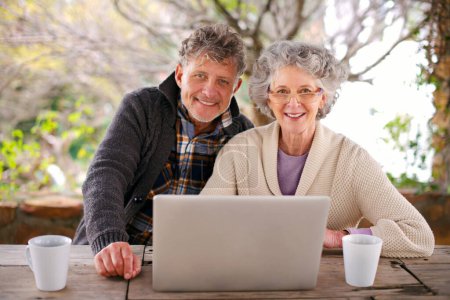 Téléchargez les photos : Couple plus âgé, sourire et portrait avec ordinateur portable pour Internet et en ligne pour se détendre ou se reposer dans le jardin pour les retraités. Pensionnés ou seniors et assis avec la technologie de streaming, web et se détendre avec du café. - en image libre de droit