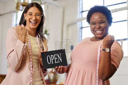 Foto de Fashion, portrait and women with open sign for small business success, celebration and achievement. Smile, tailor and excited people at launch of shop for designer clothes, retail or creative startup. - Imagen libre de derechos