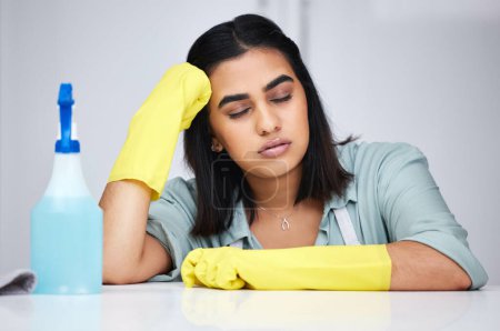 Photo for Woman, sleeping and tired cleaner with spray bottle for table, kitchen counter or dirty furniture in home. Burnout, exhausted maid and lazy Indian janitor on break with product, liquid soap or gloves. - Royalty Free Image