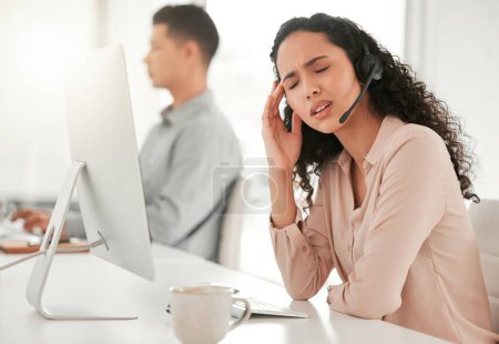 Photo for Stress, headache and woman call center consultant with computer in office with burnout for crm. Migraine, exhausted and female with headset for technical support, telemarketing or customer service - Royalty Free Image
