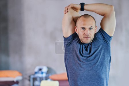 Photo for Athlete, man and stretching for fitness, exercise and workout performance for competition. Male person, healthcare and wellness with sport as hobby, daily routine and cardio for warm up or muscle. - Royalty Free Image
