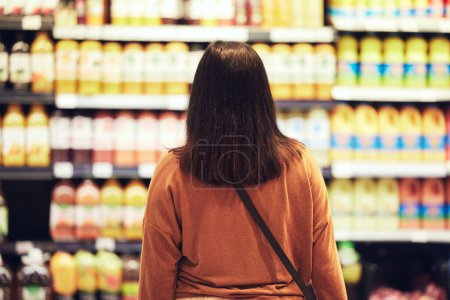 Shopping, choice or woman at supermarket for grocery, decision or product search for sale, discount or bargain. Economy, inflation or back of customer with cost, price or budget comparison at mall.
