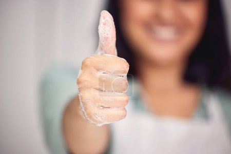 Photo for Woman, thumbs up and promotion for washing hands in home, foam and agreement on soap. Female person, antibacterial and motivation to disinfect dirt or germs, cleaning and support for satisfaction. - Royalty Free Image