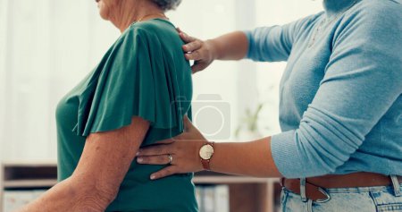 Photo for Physiotherapy, hands and back pain with doctor for healthcare service, support and physical therapy in clinic office. Physiotherapist or chiropractor with senior woman or patient for a muscle massage. - Royalty Free Image