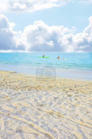 Photo for People in ocean, kayak and beach for vacation in Hawaii, nature and environment with gold sand for travel. Adventure, sports and fun in sea with coastline or shore, clouds and blue sky in summer. - Royalty Free Image