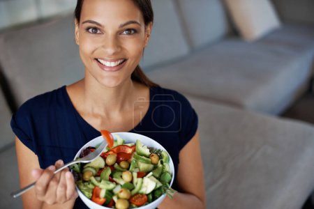 Photo for Black woman, portrait and salad for food, eating and diet on sofa, couch and lounge. Vegan lady, happy female person and vegetables for health, nutrition and wellness at home, house and living room. - Royalty Free Image