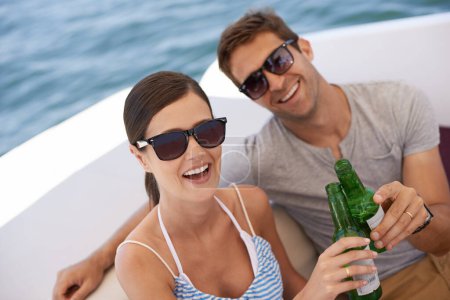 Photo for Couple, portrait and toast on yacht, boat and cruise for honeymoon, holiday and vacation. Lovers, husband and wife together for alcohol with partnership, love and marriage by sea, ocean or beach. - Royalty Free Image