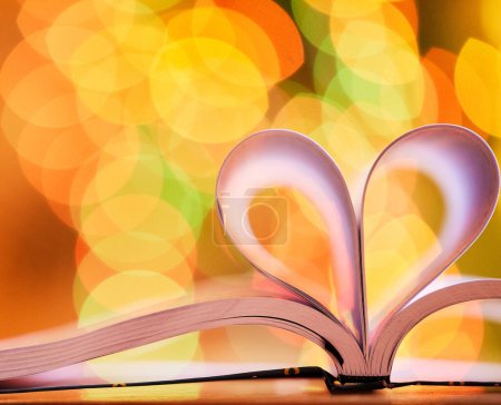 Photo for Bokeh, blurred background and open book with heart for love of reading, education and knowledge with light. Color, shape or emoji for studying, homework and learning material with care on paper. - Royalty Free Image