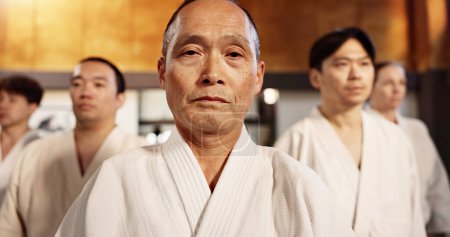 Photo for Aikido class, students or portrait for martial arts, sensei or ready for training, gym or group in dojo. Japanese people, sport or exercise in club, workout or fitness for fight, black belt or battle. - Royalty Free Image