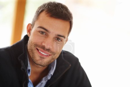 Photo for Portrait, happy man and relax in house for peace with smile, teeth and self care. Calm, happiness and face of handsome male person in home interior for wellness, positive mindset and casual comfort. - Royalty Free Image