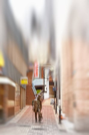Photo for City, blurred and person walking on street for morning commute with buildings, downtown and social migration. Society, alley and people on sidewalk with motion, urban travel and culture in London - Royalty Free Image
