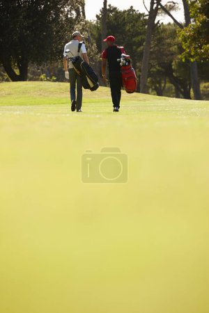 Photo for Walking, people and men together on golf course with golfing bag for training, health and teamwork. Male friends, sports equipment and exercise for activity with sportswear, lawn and trees outdoor. - Royalty Free Image