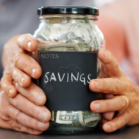Photo for Married hands, money and mason jar for insurance, retirement or savings plan. Senior couple, cash or bills for pension, banking or investing together and generational wealth opportunity for family. - Royalty Free Image