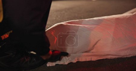 Photo for Crime scene, dead body and cover for accident at night in road, street or outdoor with paramedic or 911. Death, first responder and woman murder, violence or homicide with law enforcement or medic. - Royalty Free Image