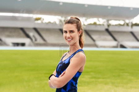 Photo for Arms crossed, fitness and portrait of sports woman in stadium or competition, performance or training. Exercise, health and workout with confident athlete or runner at event venue for start of race. - Royalty Free Image