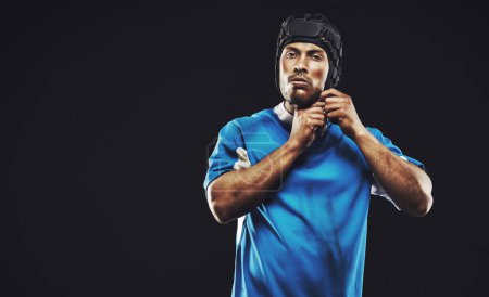 Photo for Black background, portrait and man ready for rugby match or training, serious and focused for fitness. Male player, determination and professional for football game, athlete and strong for workout. - Royalty Free Image