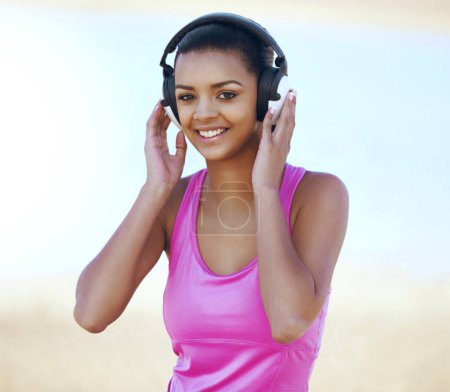 Photo for Sports, portrait and woman with headphones outdoor listening to music, podcast or radio for running. Fitness, nature and Mexican female athlete runner streaming song for cardio workout or training - Royalty Free Image
