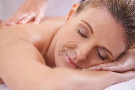 Photo for Woman, relax and hands massage in spa, wellness and resting in hotel or lodge. Physical therapy, holistic and female person in holiday or vacation in California for health, peace and back skin detox. - Royalty Free Image