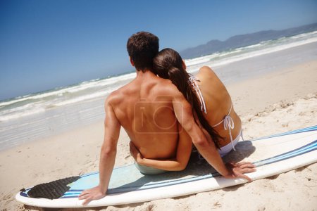 Photo for Back, surfboard and beach with couple, holiday and travel with honeymoon, view and relationship. Seaside, relax and man with woman and surfer with sunshine and vacation with getaway trip and marriage. - Royalty Free Image