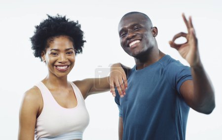 Photo for Black couple, portrait and fitness with ok sign for workout, training or exercise on a white studio background. Happy African man or woman with smile, like emoji or okay for health or body perfection. - Royalty Free Image