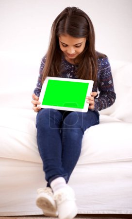 Photo for Home, green screen or child with tablet for mockup, playing games or streaming videos on movie website. Space, online or female kid with ebook or technology to download on social media app on sofa. - Royalty Free Image