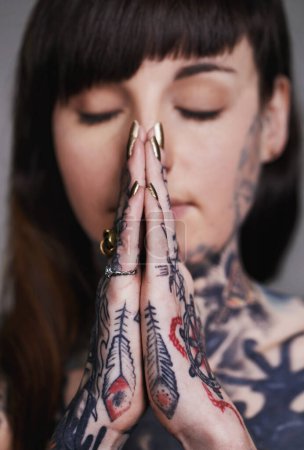 Photo for Woman, tattoo and pray for ink, faith and creative for belief, religion and spiritual for design on closeup. Young person and eyes closed for zen, namaste and nails for varnish and symbol for edgy. - Royalty Free Image