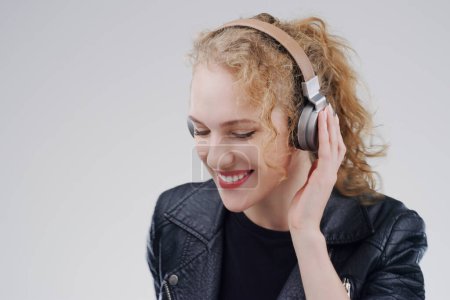 Photo for Relax, music or happy woman in headphones in studio for singing or streaming on grey background. Mockup space, face or girl listening to radio playlist, sound or podcast audio subscription with smile. - Royalty Free Image