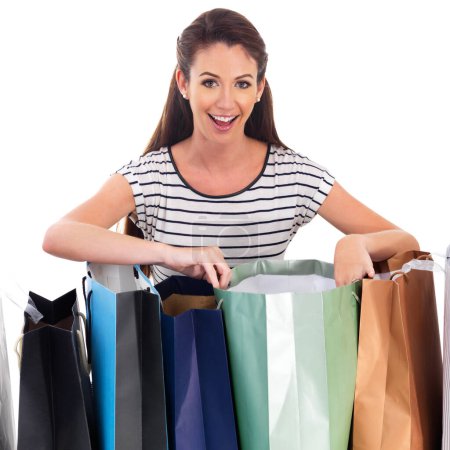 Photo for Bags, shopping and surprise with portrait of woman in studio isolated on white background for bargain or sale. Retail, store or wow and happy young shopper with product in package for discount. - Royalty Free Image