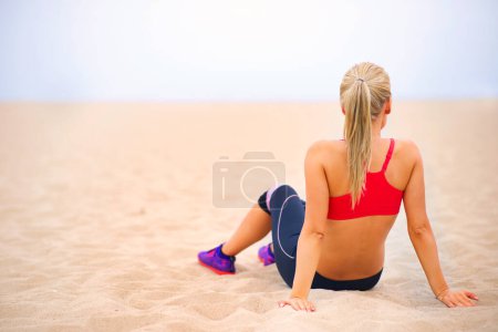 Foto de Fitness, relax y espalda de mujer en la playa para hacer ejercicio, entrenamiento y entrenamiento en la naturaleza. Verano, deportes y persona en la arena para el calentamiento, el descanso y la vista panorámica para el bienestar, la salud y activo por el océano. - Imagen libre de derechos