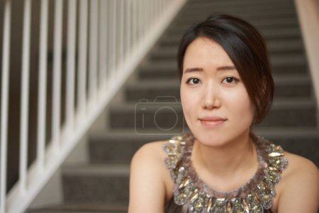 Photo for Woman, portrait and stairs in office, entrepreneur and designer in Japan for company. Asian female person, steps and professional for business, pride and career opportunity for creative employee. - Royalty Free Image