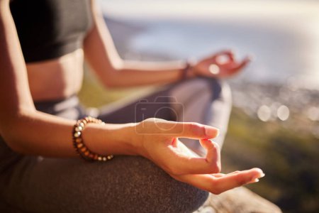 Mountain, peace and hand of woman with meditation for spiritual healing, awareness and faith. Zen female person, calm and relax in nature with lotus pose for chakra exercise, balance and mindfulness.