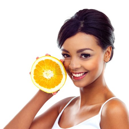 Photo for Portrait, smile and woman with orange, nutrition and sustainable eating to lose weight in studio. Fruit, face and girl with fresh food for detox diet, vitamin c and gut health on white background - Royalty Free Image