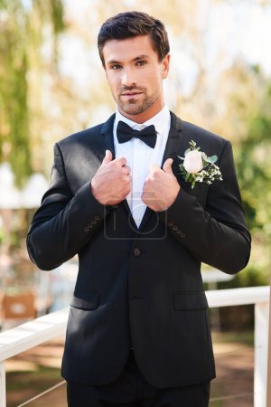 Photo for Man, portrait and groom in suit on wedding day outdoor or flower boutonniere, commitment or celebration. Male person, face and marriage reception or summer ceremony in garden park, milestone or event. - Royalty Free Image