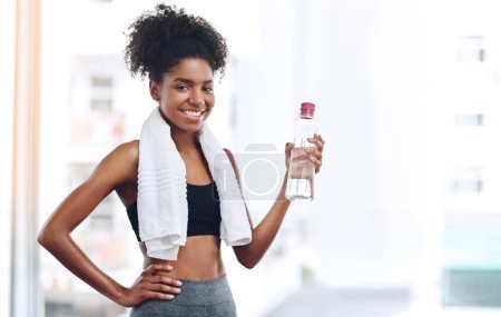 Photo for Happy, black woman and fitness with water and towel after cardio training or practice for wellness. Young, female person and athlete with smile and bottle after workout or exercise for hydration. - Royalty Free Image
