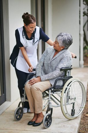 Photo for Disabled patient and wheelchair at nursing home with nurse for assistance with disability, help at clinic. Senior woman or medical or outdoors for talk or plan for healthcare, conversation with carer. - Royalty Free Image