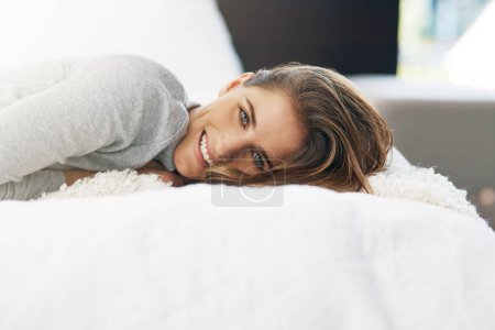 Photo for Woman, portrait and relax on bed in home with smile or weekend morning for peace, calm or resting. Female person, face and stress relief in apartment or comfort day off for Saturday, leisure or lying. - Royalty Free Image