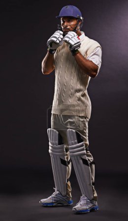 Photo for Man, cricket and athlete for sports match with confidence in studio on black background or exercise, fitness or game. Male person, helmet and gear for professional competition, training or mockup. - Royalty Free Image