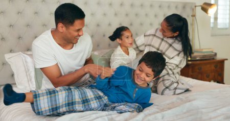 Photo for Family, play and bedroom with children happiness for fun or bonding at house for quality time. Energy, playful and bed with parents or kids in family home with funny or crazy with freedom with game - Royalty Free Image