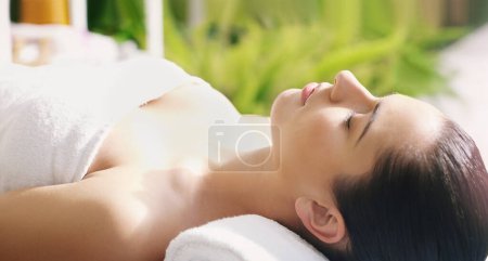 Photo for Spa, relax and woman on massage table for stress relief, body or beauty treatment at wellness resort. Luxury, peace and pamper on vacation at Thailand salon for healing, therapy or cosmetic service. - Royalty Free Image