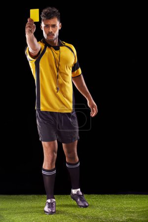 Photo for Portrait, referee or man with a yellow card for warning, foul call or penalty review in sports game on turf. Soccer match, discipline or person with punishment, rules or caution on black background. - Royalty Free Image